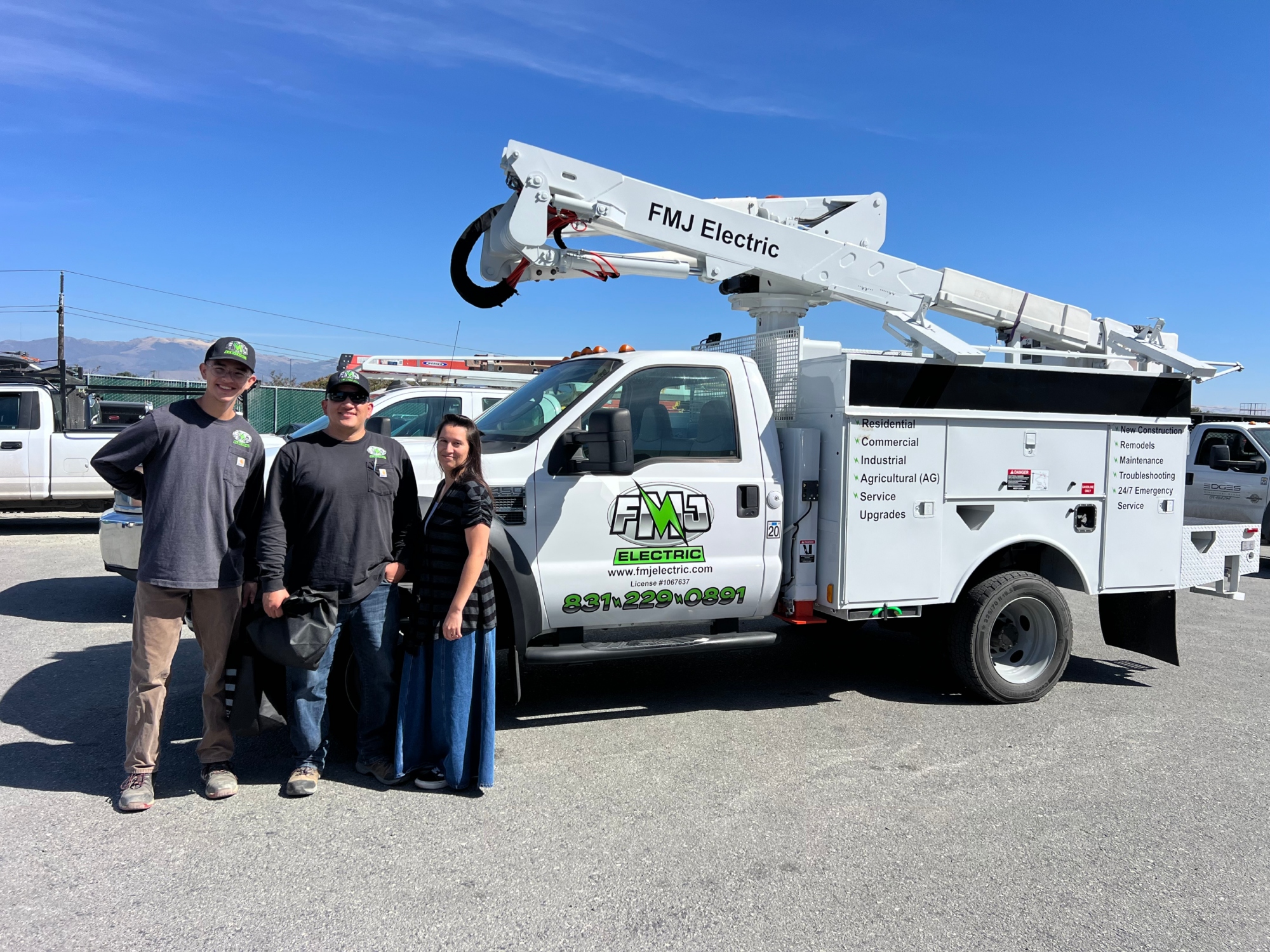 2 FMJ Electric truck performing electrical outlet installation service near Salinas River