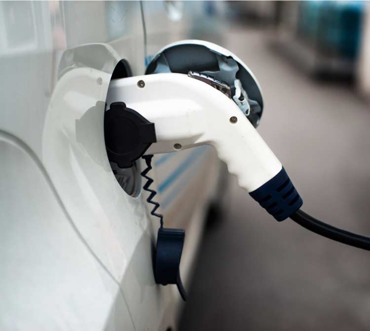 Electric-Vehicle-Charging-Station-Installation Safely mounted home electric vehicle charging station installation and charging a vehicle.